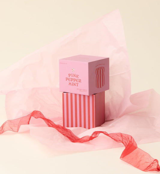 Pink striped box with a pink bow on a light pink background